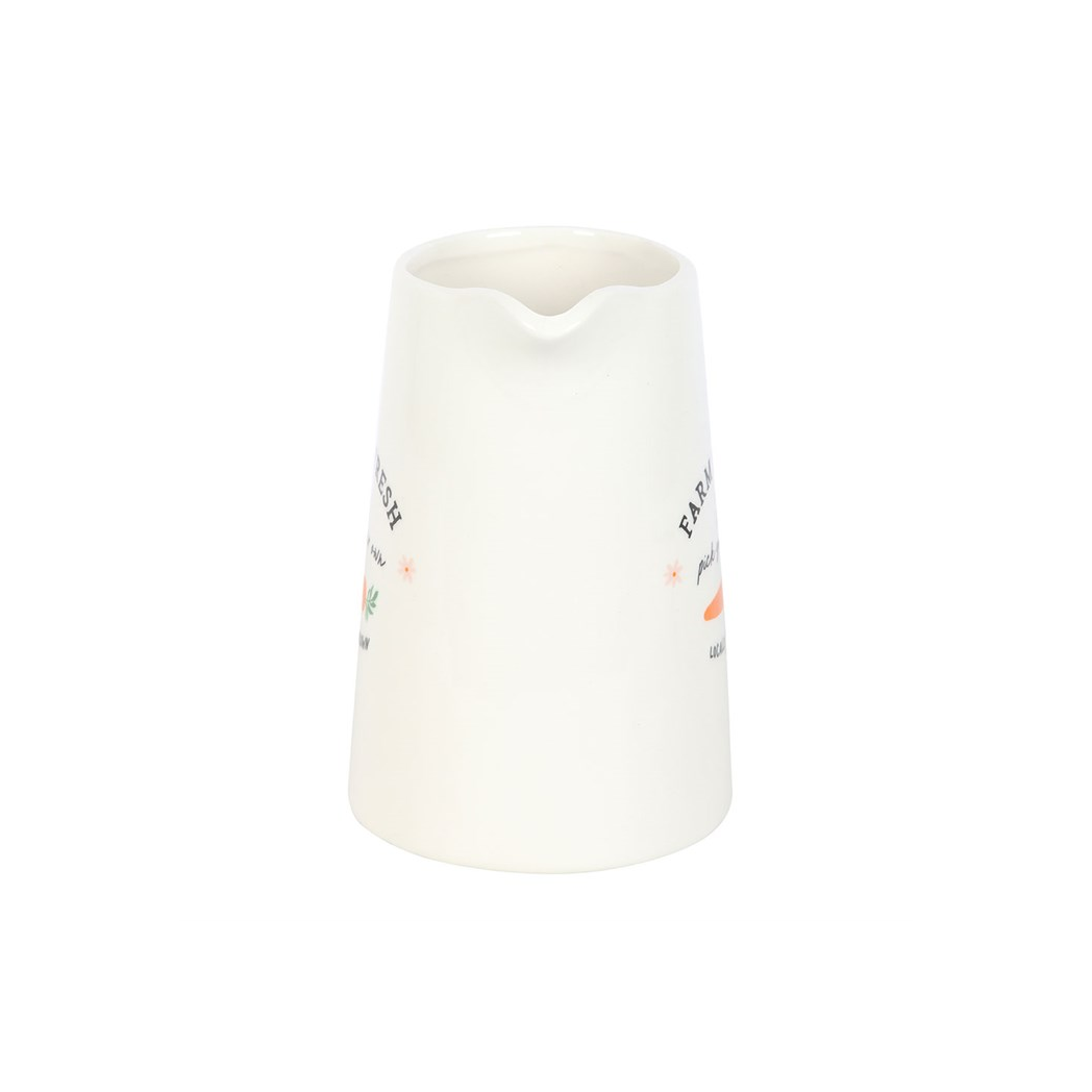 White ceramic pitcher with green handle