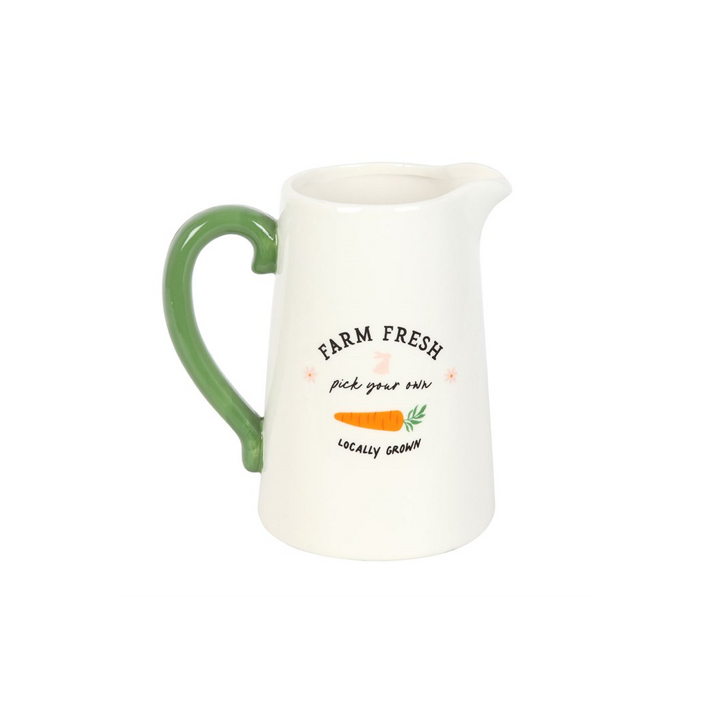 White pitcher with green handle and 'Farm Fresh' text on a white background