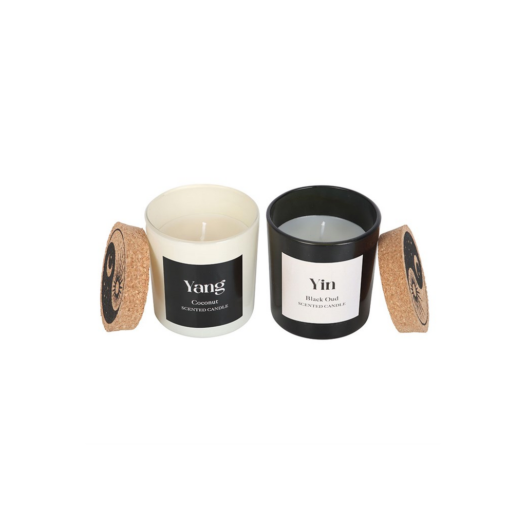 Two candles labeled 'Yang' and 'Yin' with cork lids on a white background