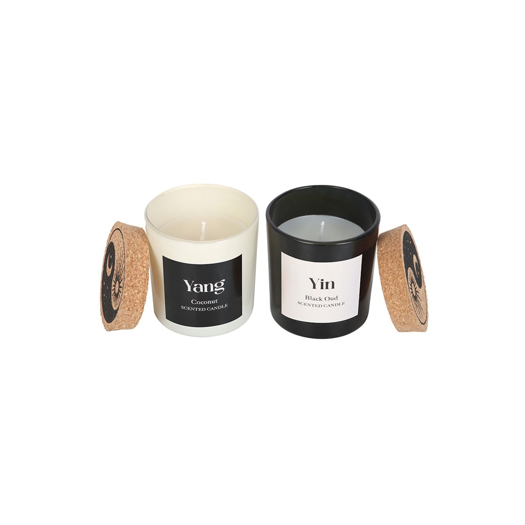 Two candles labeled 'Yang' and 'Yin' with cork lids on a white background