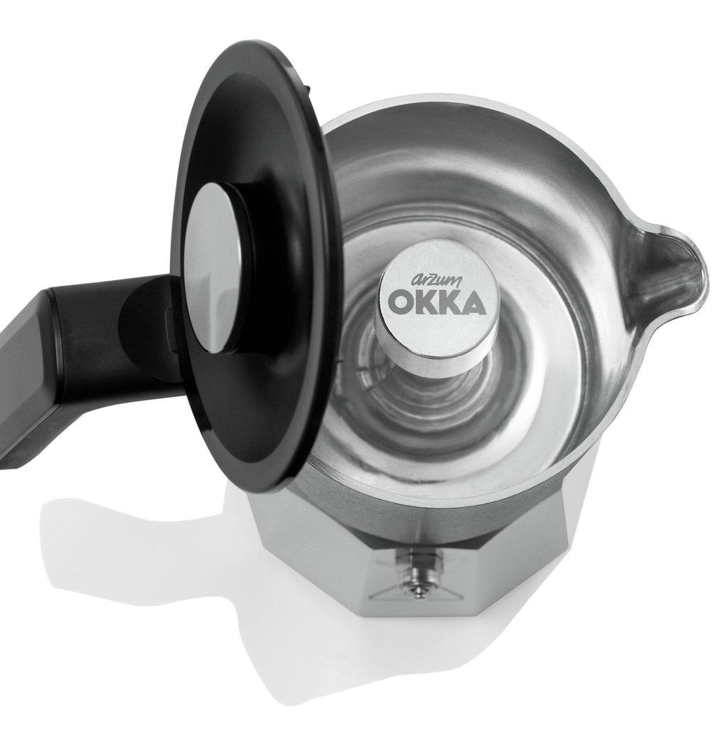 Stainless steel espresso maker with black handle on a white background, featuring the OKKA brand.