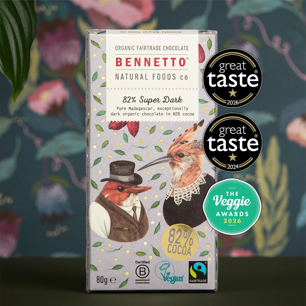 A boxed chocolate bar package from Bennett Natural Foods Co. stands upright against a decorative floral background.