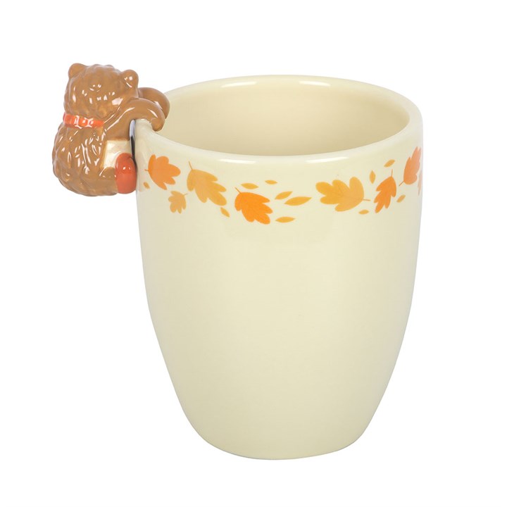 Ceramic plant pot with hedgehog handle and autumn leaf pattern on a white backgroundg