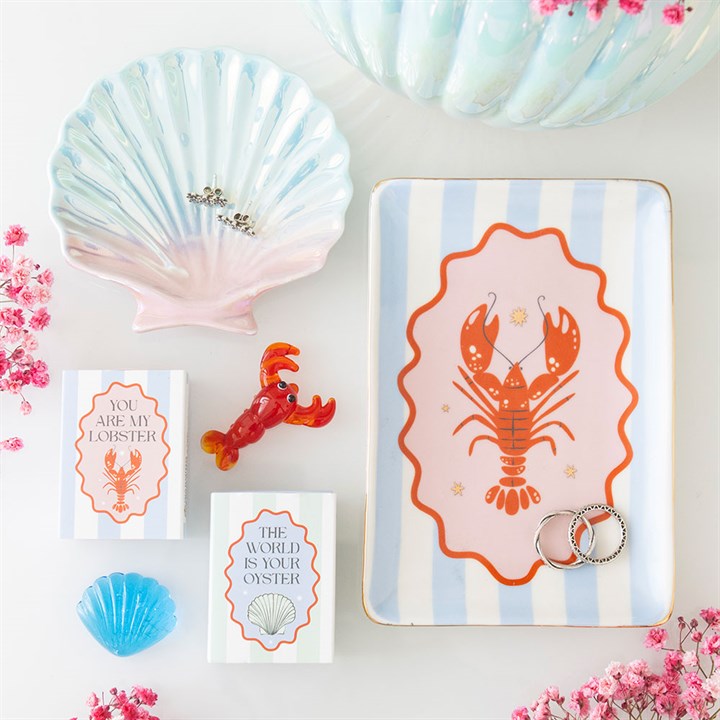 Decorative items with lobster and shell designs on a light background