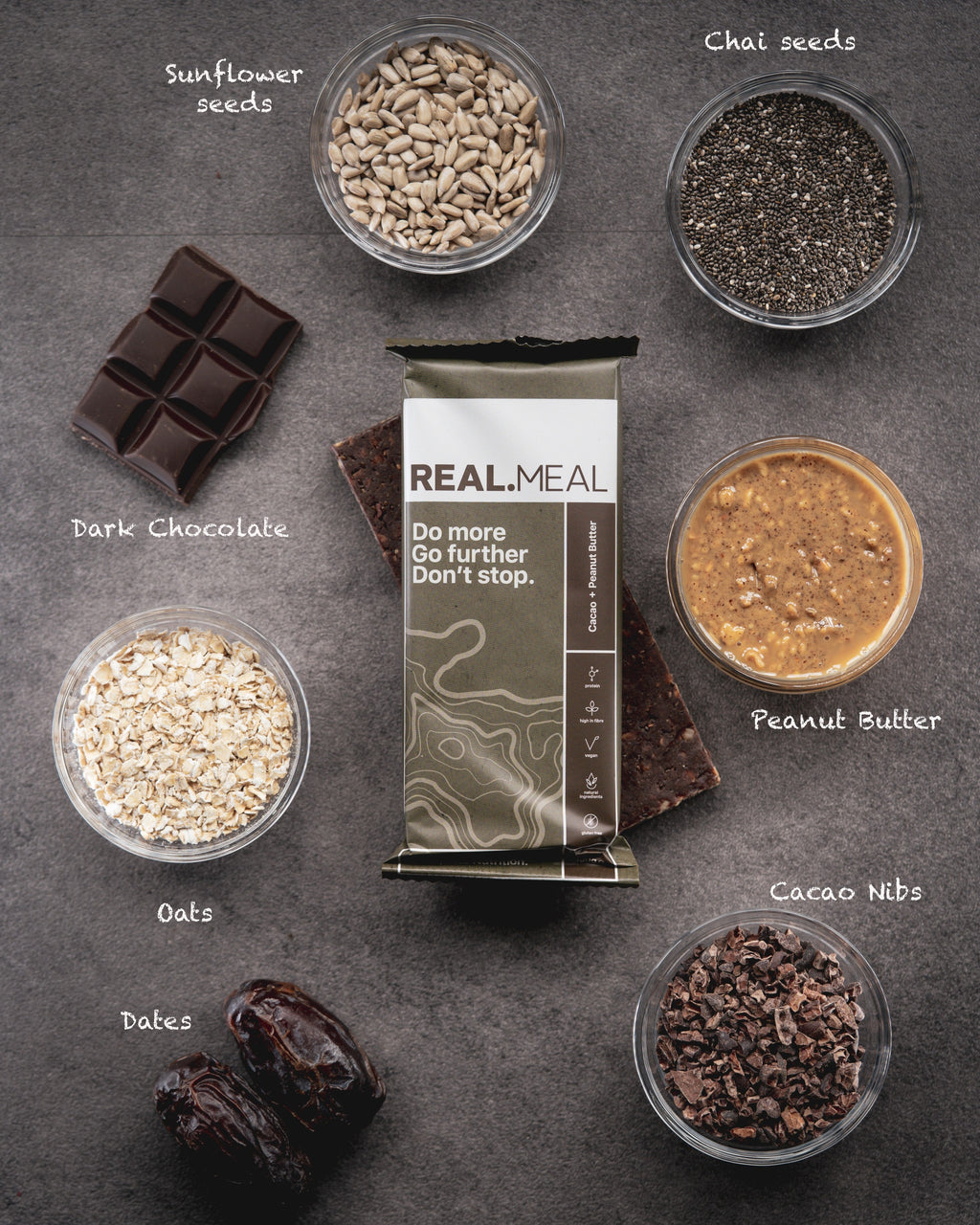 Real Meal package surrounded by ingredients on a dark surface
