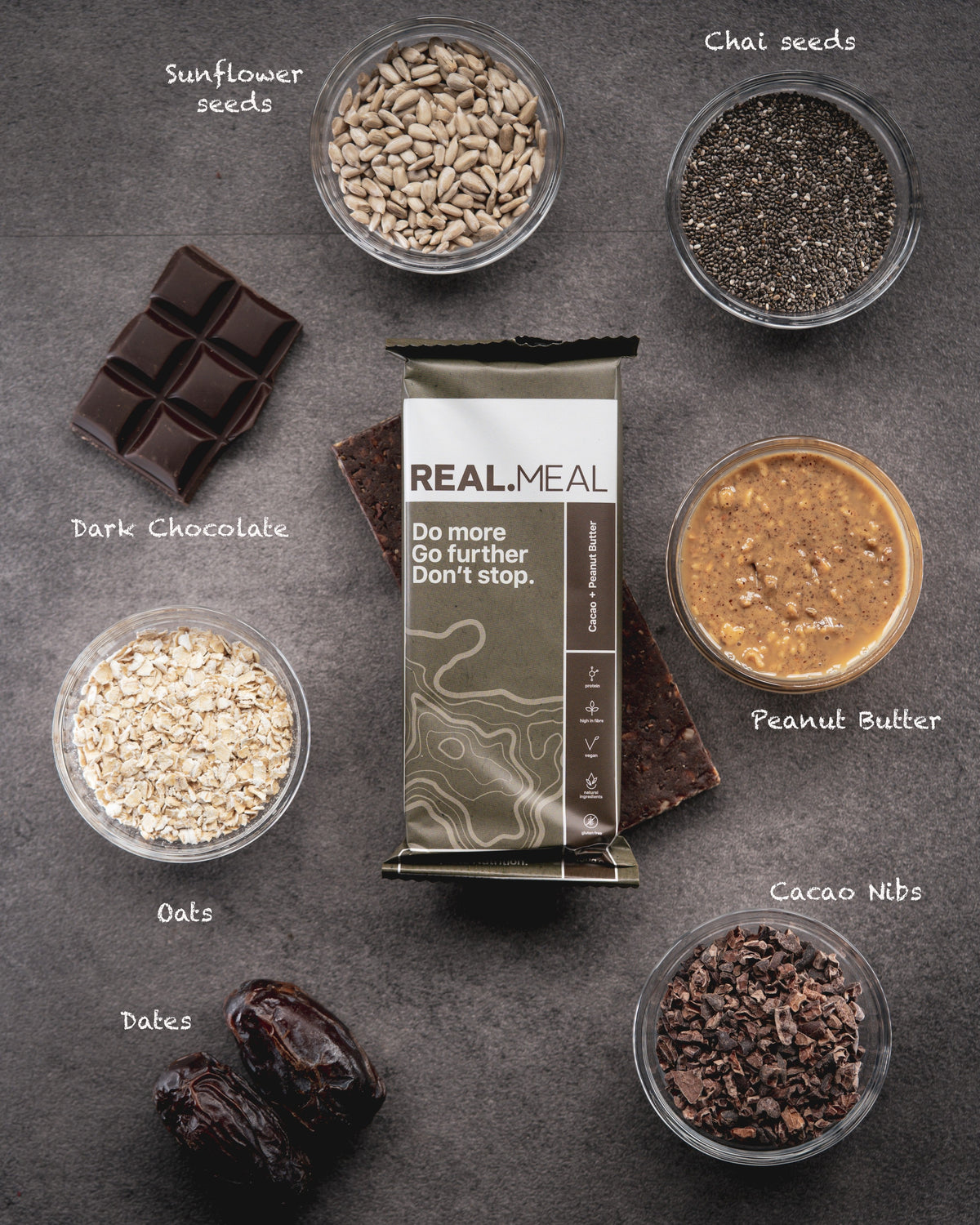 Real Meal package surrounded by ingredients on a dark surface
