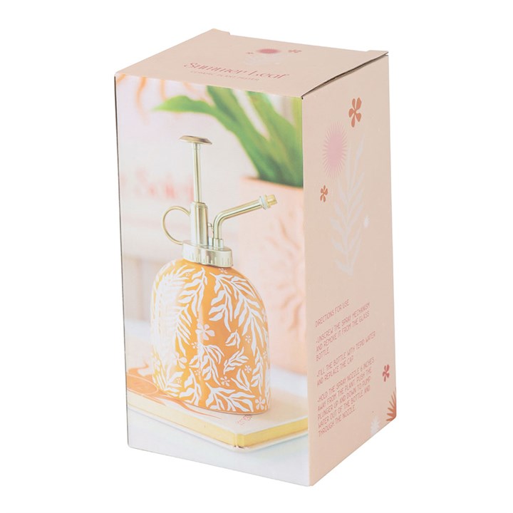 Decorative plant watering can in packaging with floral design