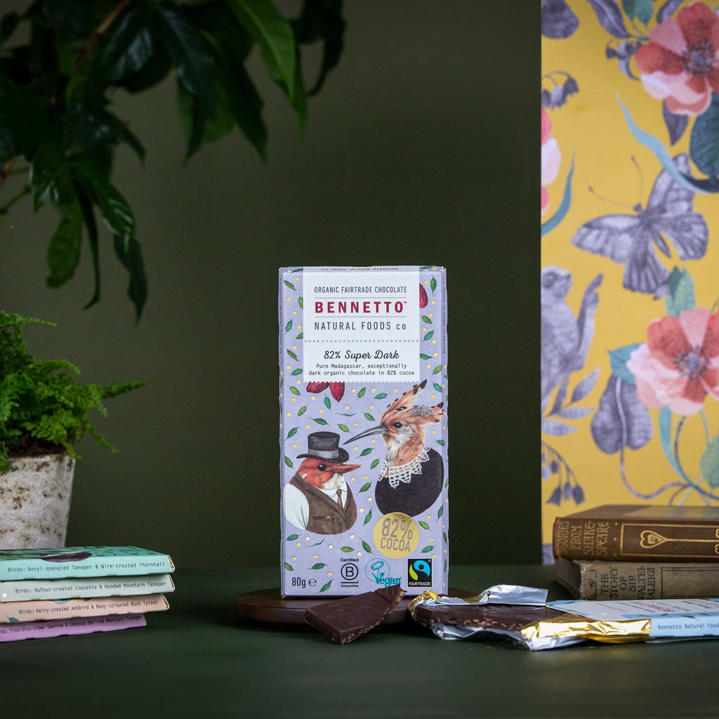 Bennetto chocolate bar packaging on a table with books and a plant in the background