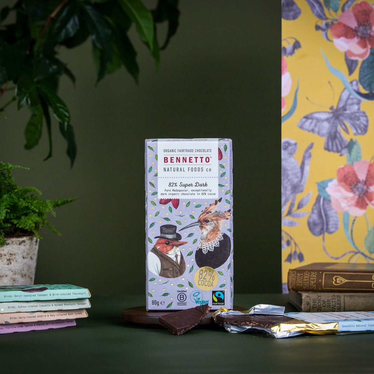 Bennetto chocolate bar packaging on a table with books and a plant in the background