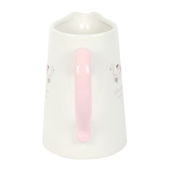 White ceramic vase with a pink accent on a white background